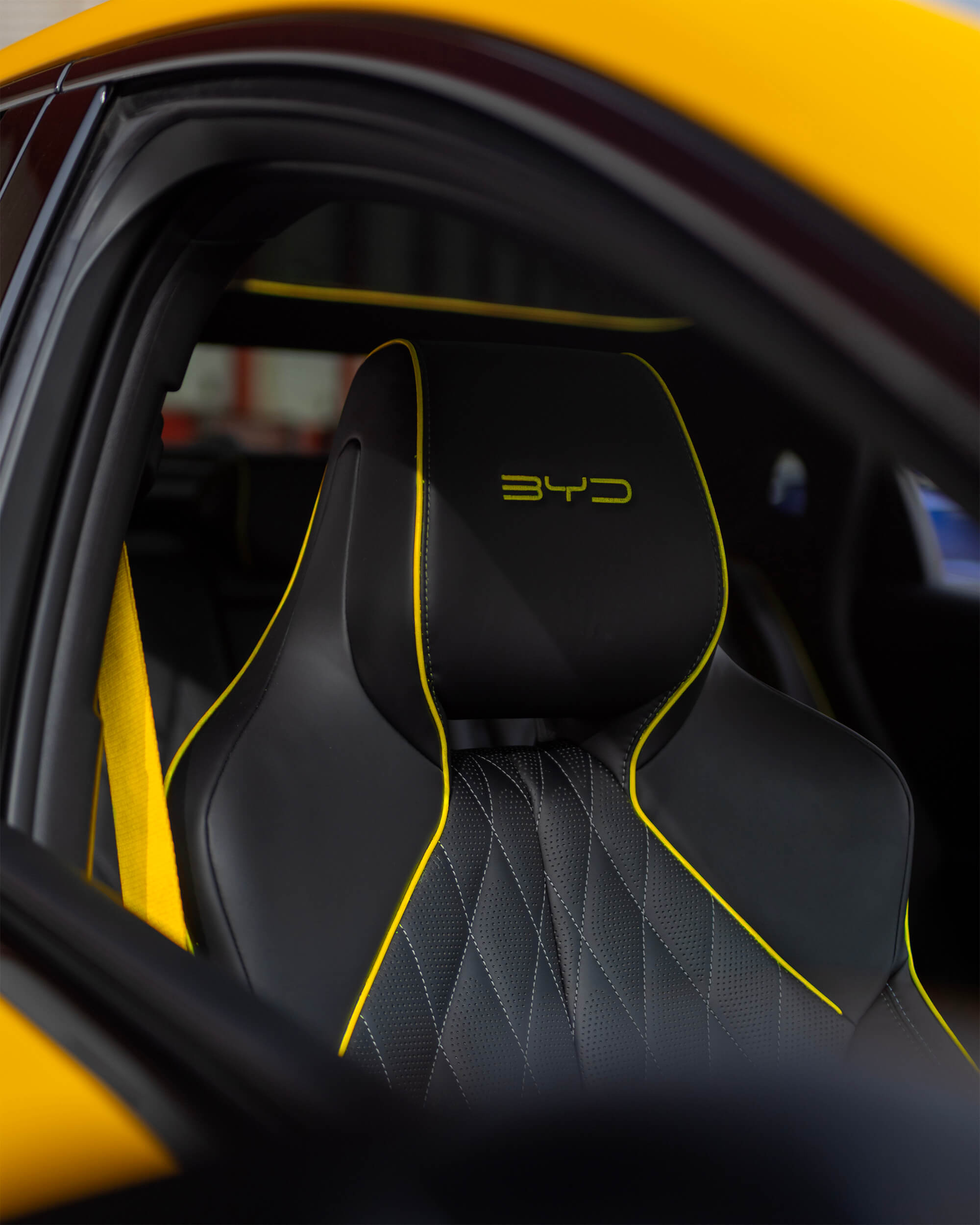 Detalle del asiento delantero del BYD Seal Performance con bordado amarillo y logotipo BYD
