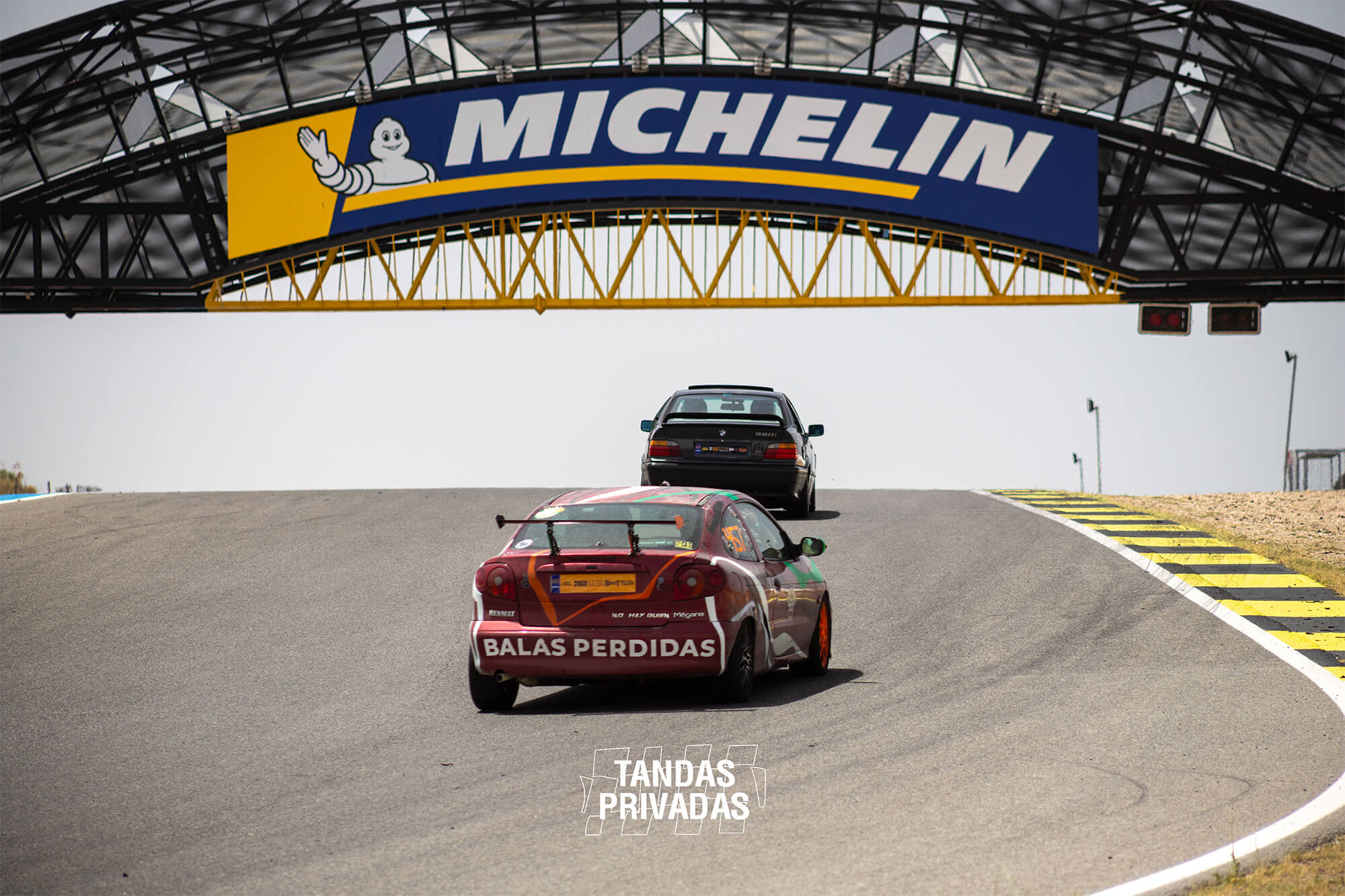 Dos coches rodando bajo el puente Michelin durante Tandas Privadas en el Jarama